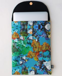 Floral laptop sleeve in blue, orange and white.